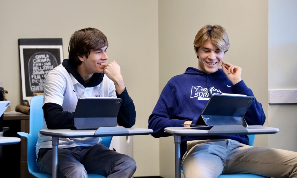 two male Pacifica students in desks