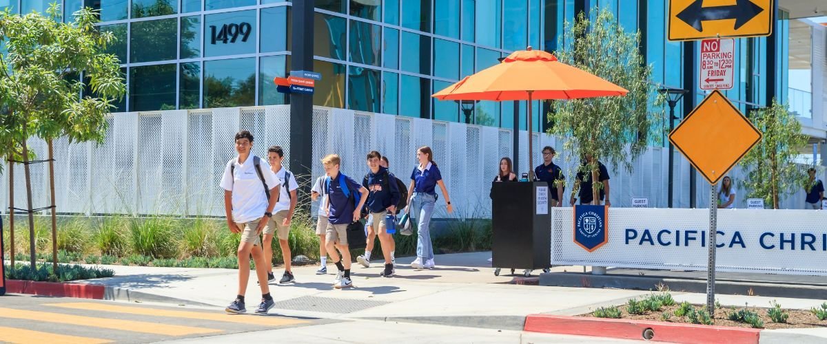 students walking on sidewalk in front of Pacifica Orange County campus