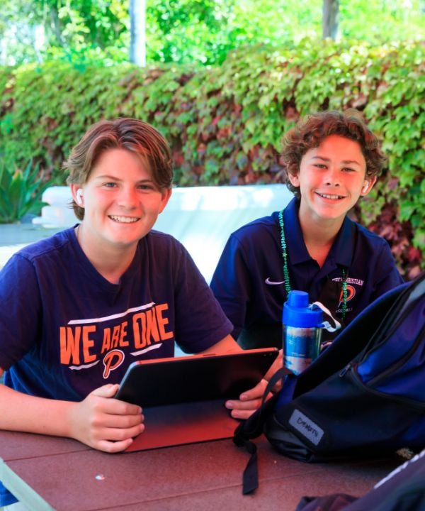 two students sitting outside
