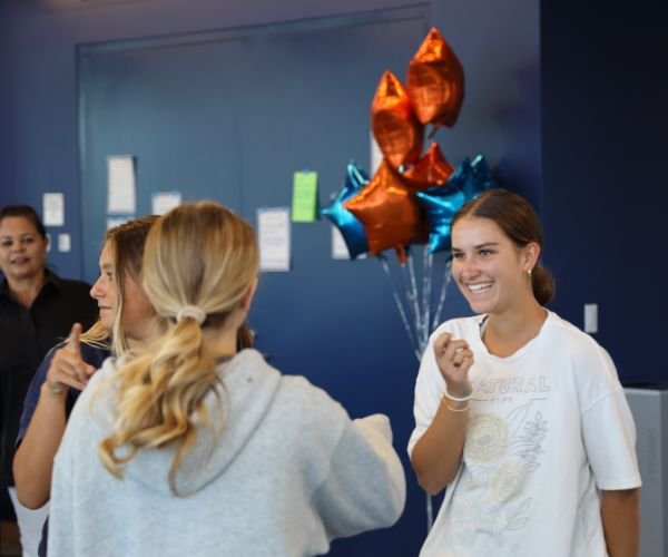 two Pacifica students celebrating with balloons