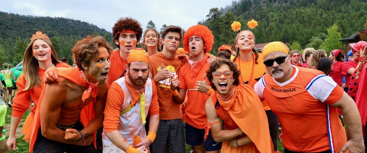 group of Pacifica students and alums dressed in orange