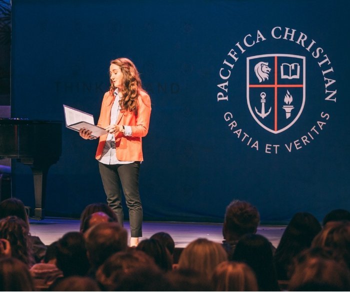 Pacifica student presenting on stage